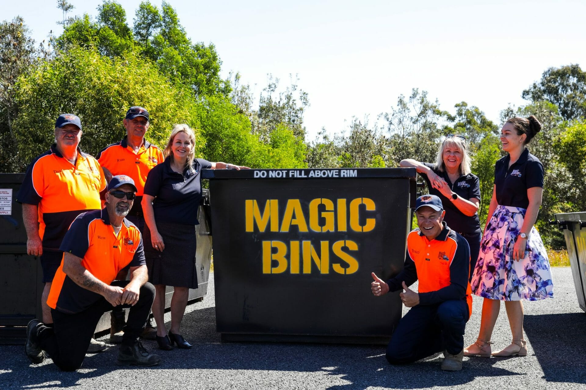 Magic bins team next to skip bin